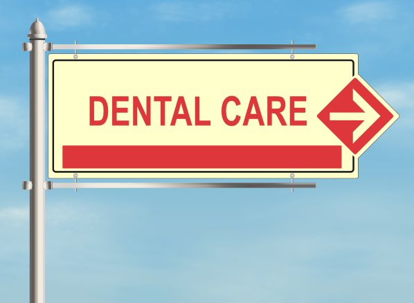 Directional sign indicating the way to dental care services at an affordable Dallas dentist, with an arrow pointing to the right.