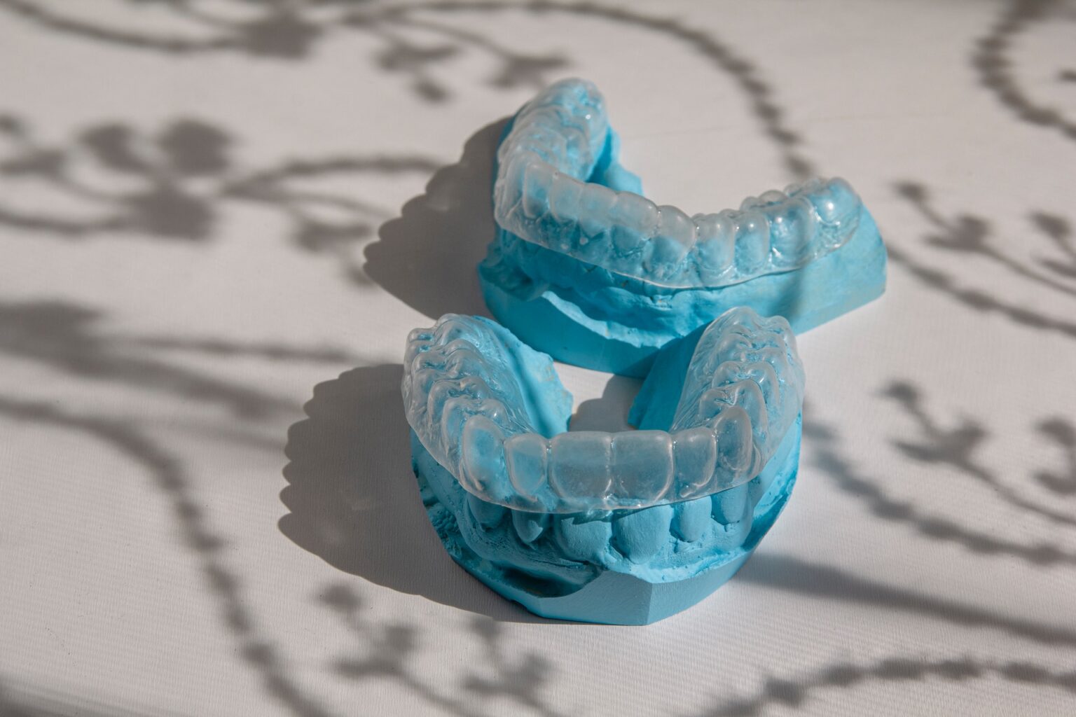 Dental impressions on a patterned surface casting shadow in Dallas dentistry.