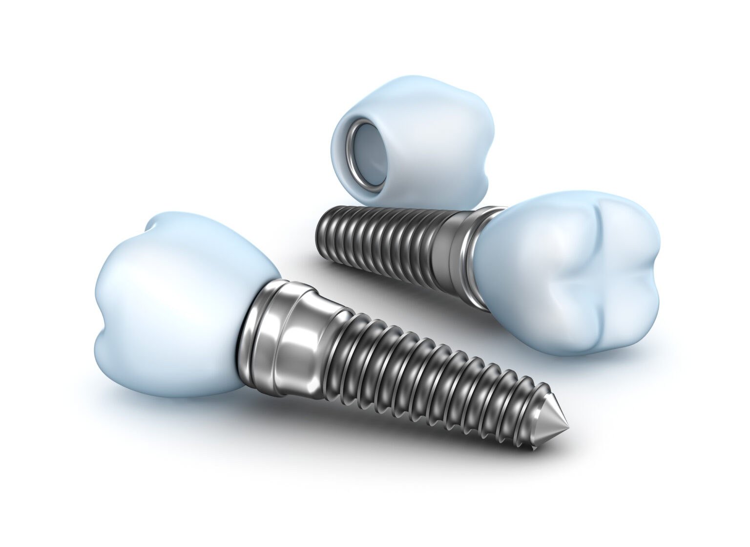 Three dental implants of different parts and stages on a white background in a Texas dentistry office.