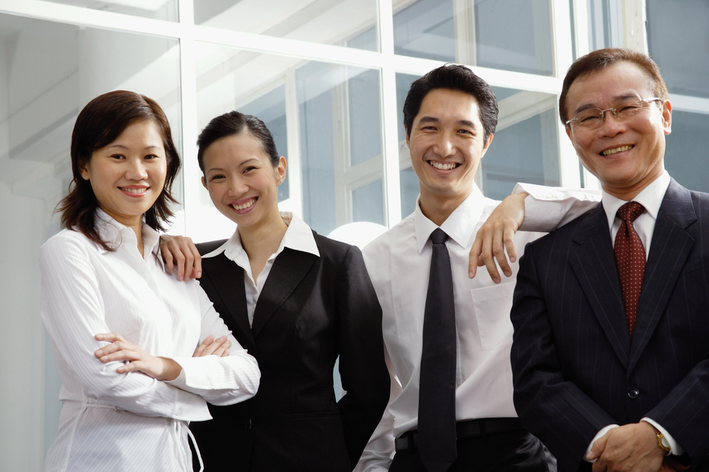 four professional adults with smiles